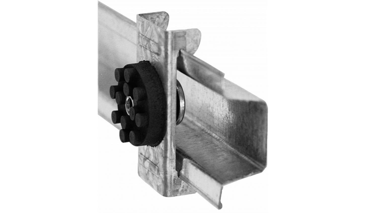 Close-up of a sound isolation clip with a rubber element for decoupling walls during soundproofing